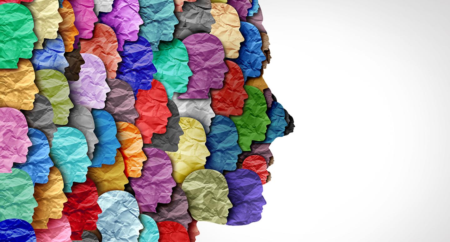 Counseling concept with colored paper faces making the shape of a head in profile