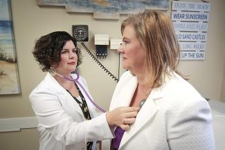 Primary Care physician listening to a patient's heartbeat with stethoscope